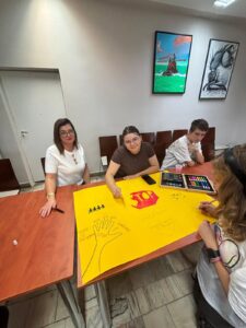 Czworo wychowanków Bursy Szkolnej prezentuje wspólnie przygotowany plakat „Stop przemocy, start szacunku”, promujący przeciwdziałanie przemocy, szacunek i wzajemną pomoc.
