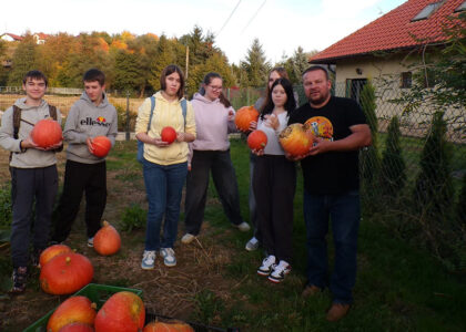 Wychowankowie Bursy Szkolnej w Miechowie podczas warsztatów artystyczno-integracyjnych z okazji Halloween. Zdjęcia przedstawiają zbieranie dyń w gospodarstwie rolnym, tworzenie halloweenowych lampionów, malowanie ozdób gipsowych oraz wspólną pracę i integrację młodzieży podczas zajęć.